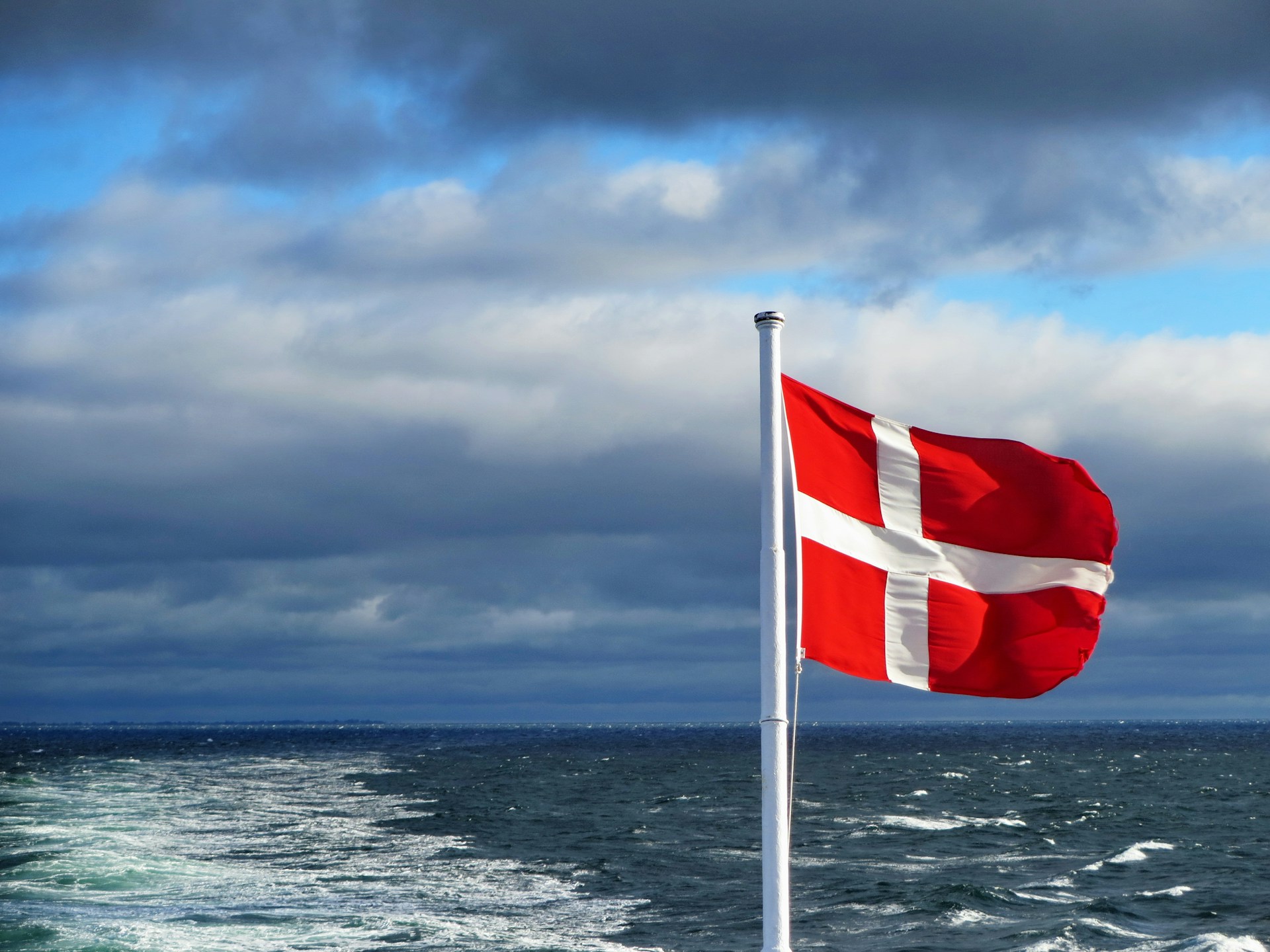 The Danish flag flying off the stern of a boat