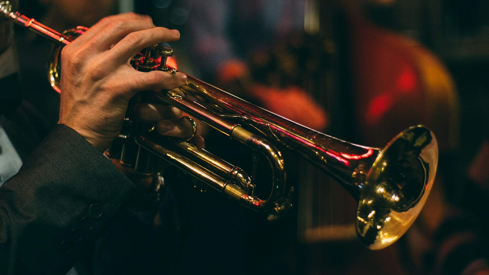 A person playing a trumpet in a jazz lounge