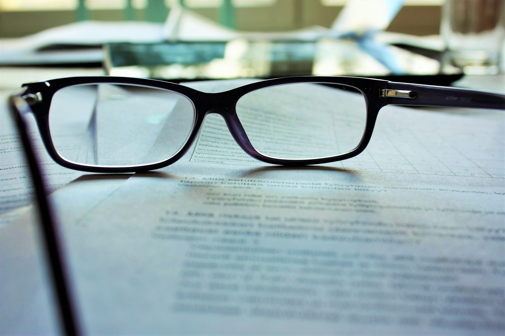 A pair of glasses lying on a typed document