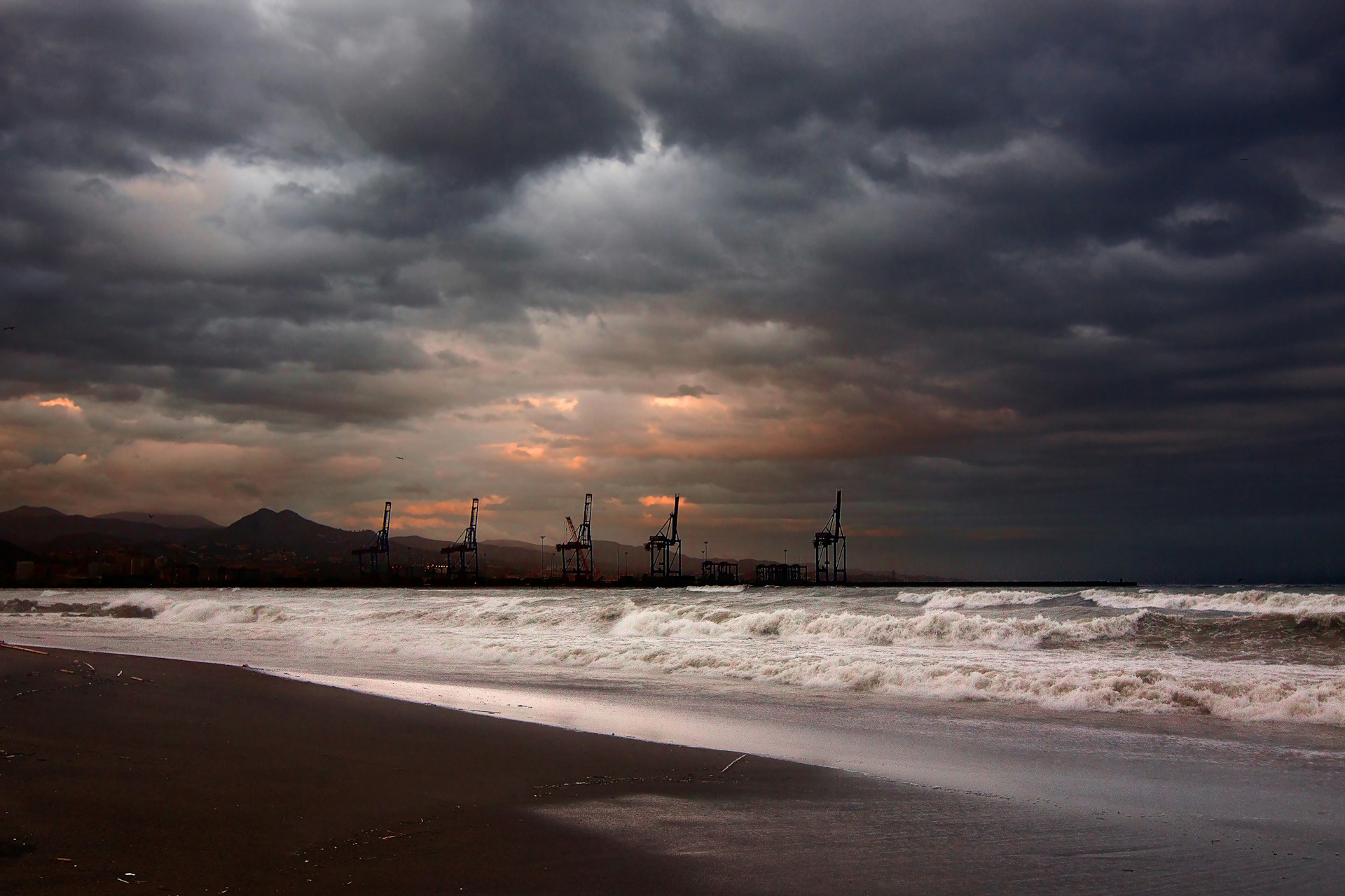 Oil wells on the horizon at sunset