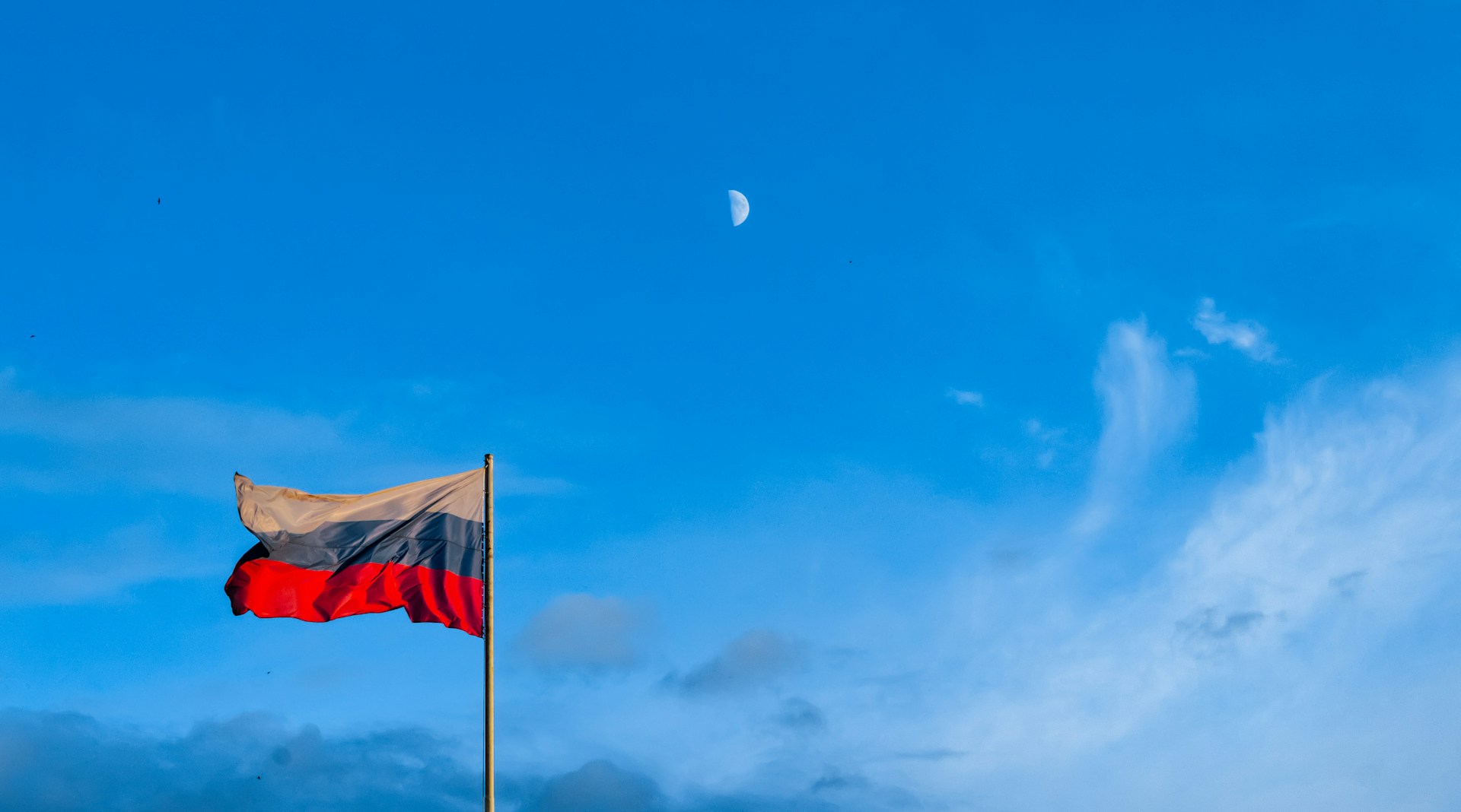 A Russian flag against a blue sky