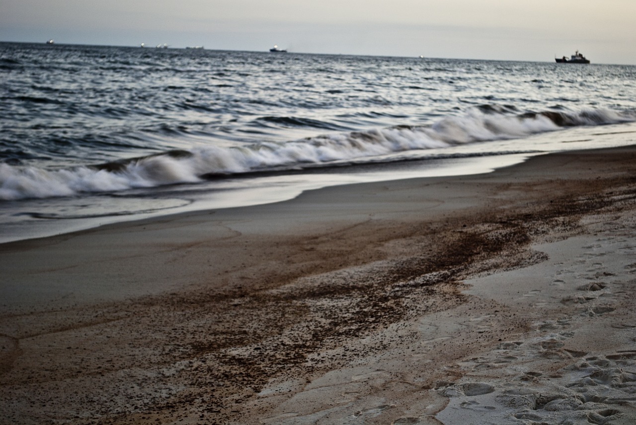 An oil spill in water along a coastline