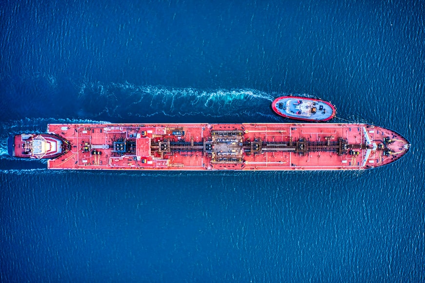 A drone view of an oil tanker and tugboat