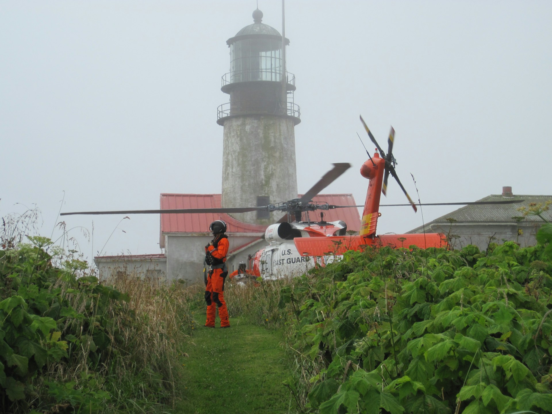 A US Coast Guard helicopter landed beside a lighthouse