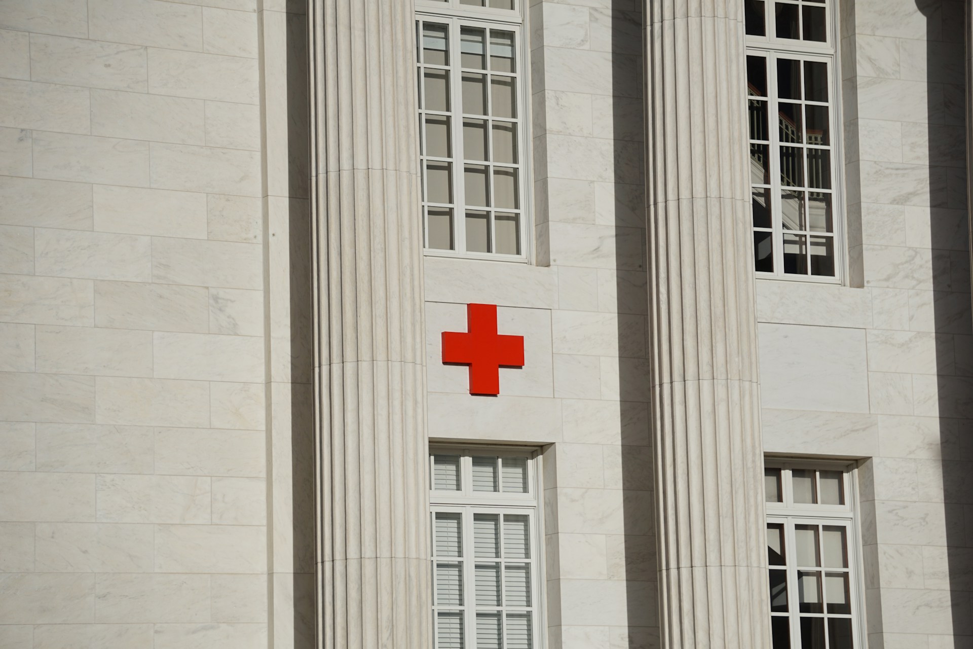 A red cross on a hospital exterior