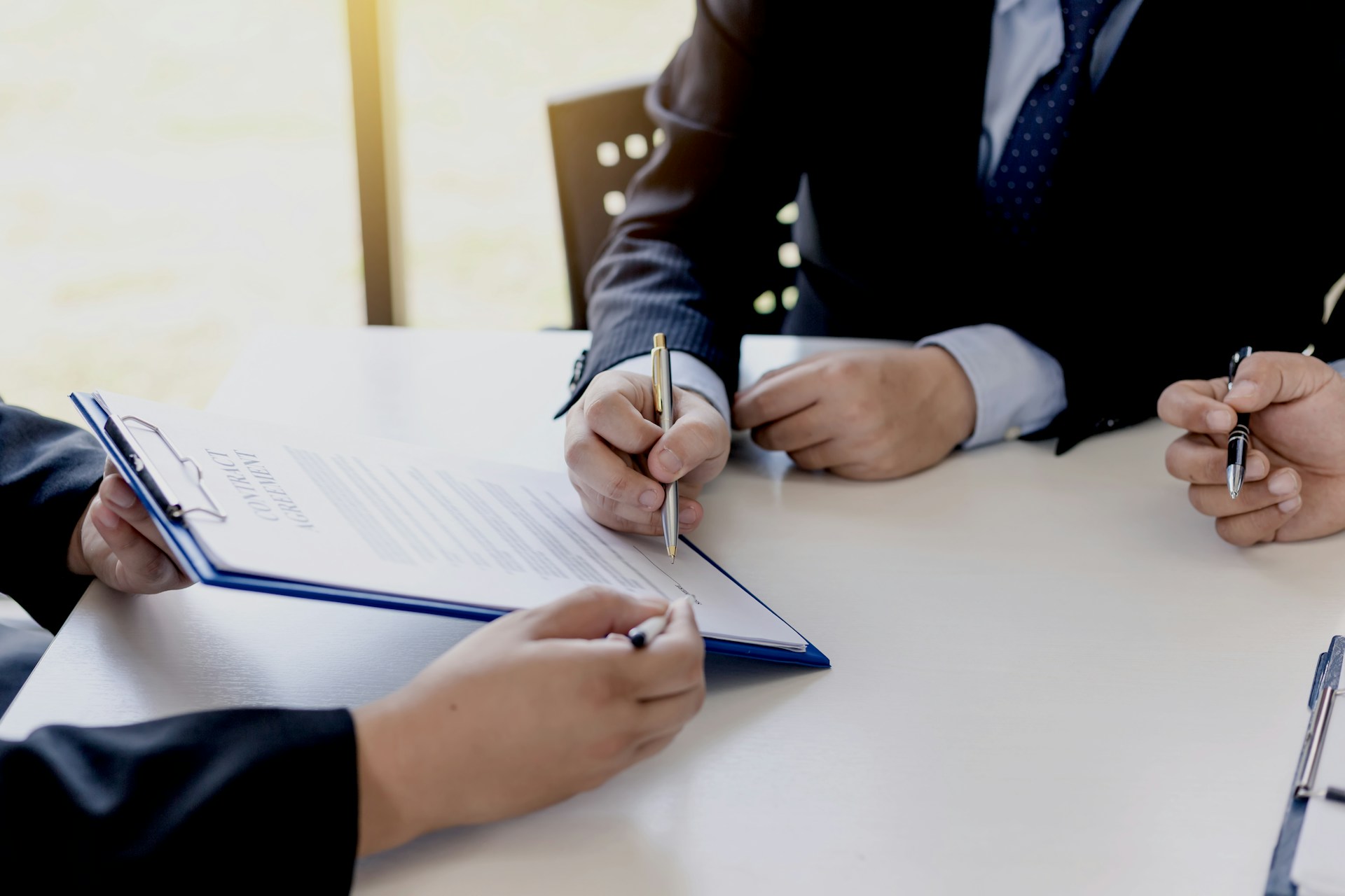 People in business attire signing a contract