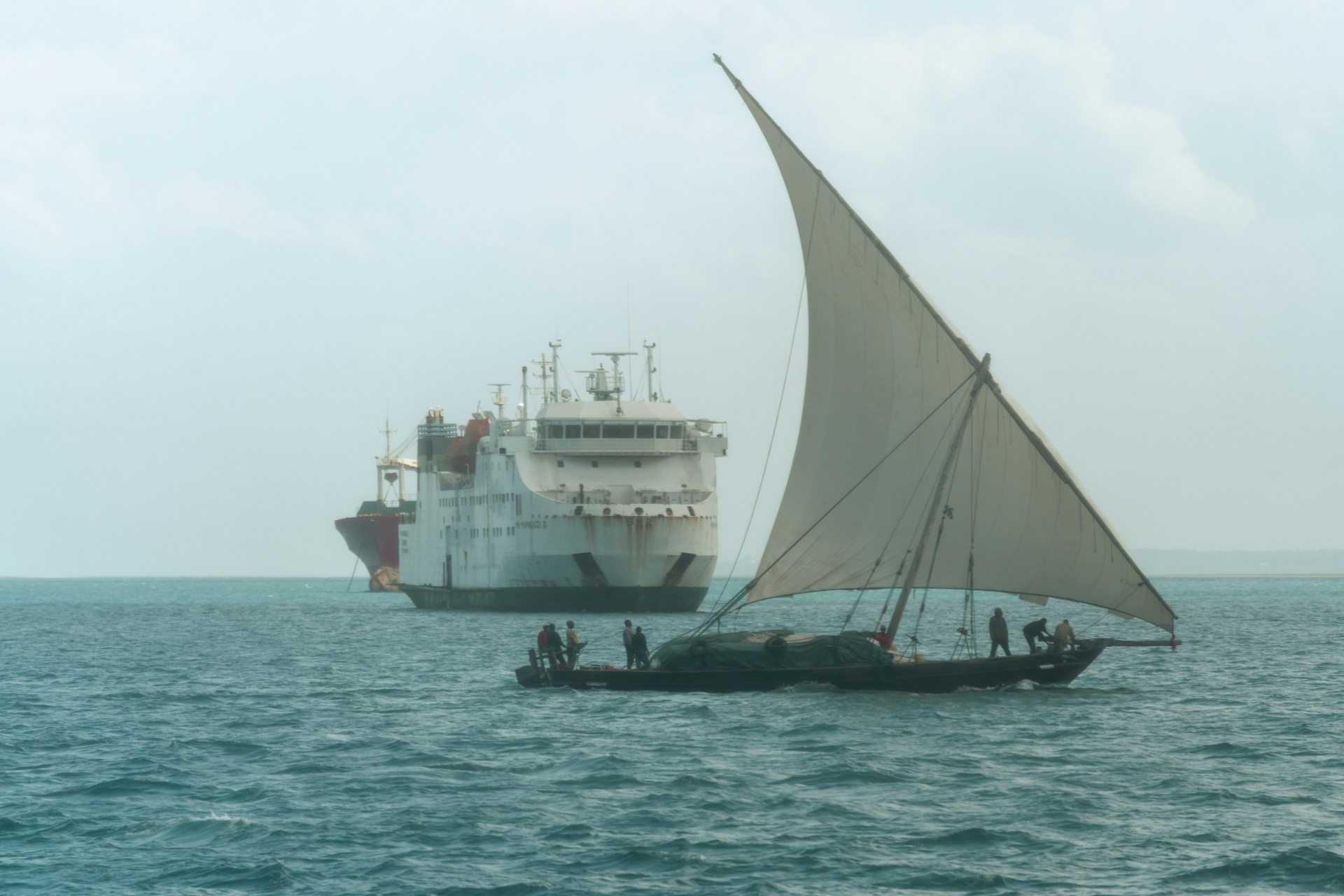 A dhow and cruise ship at sea