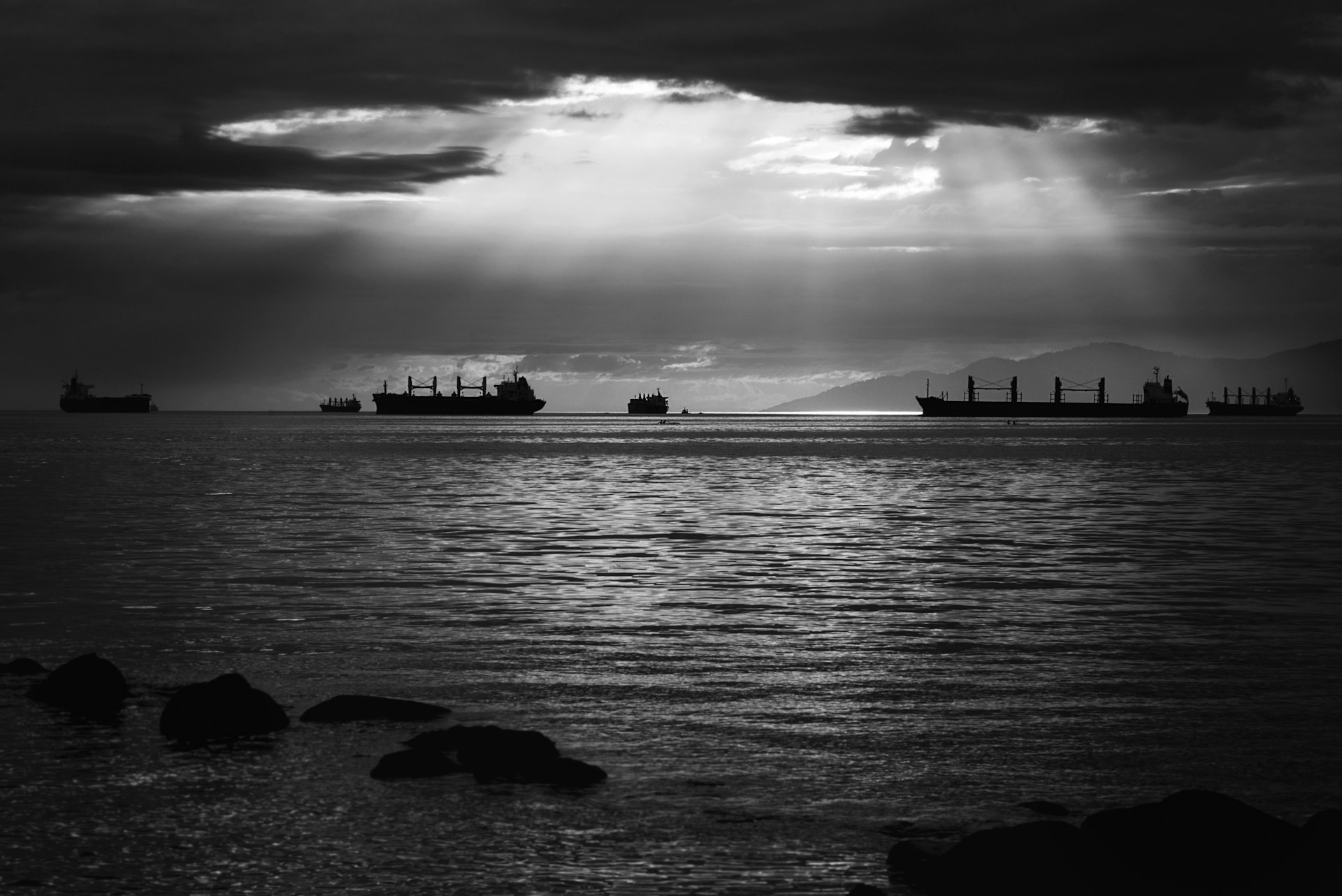 Silhouettes of various vessels at sea