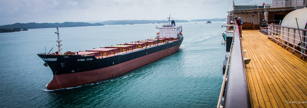 A bulk carrier passing a cruise ship