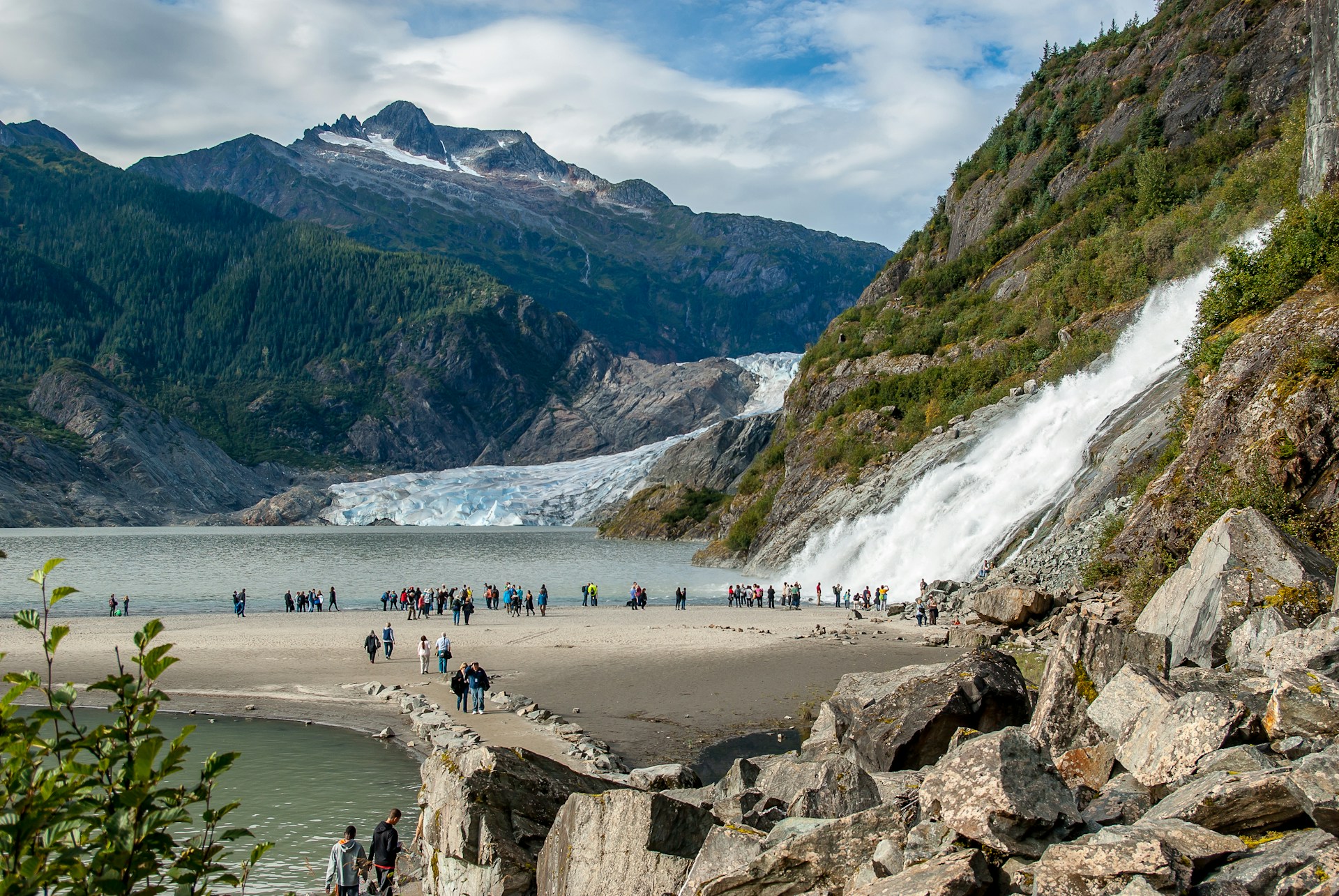 People standing by a glacier in Juneau, Alaska