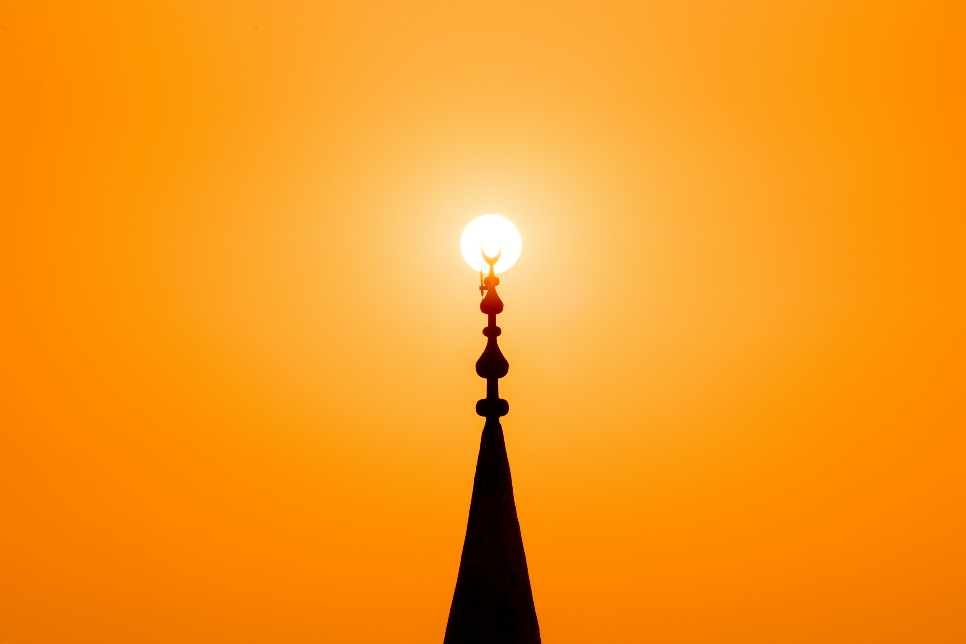 The minaret of a mosque at sunset