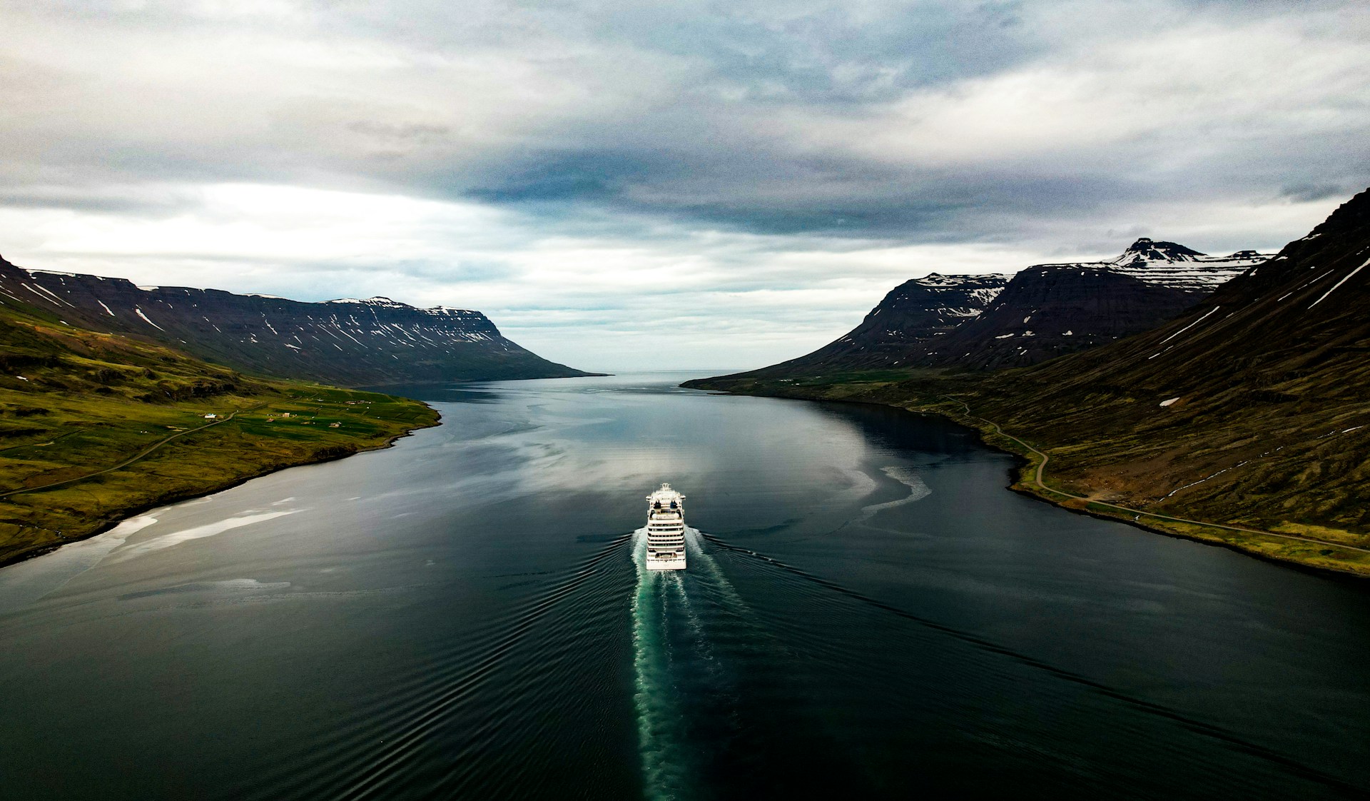 A cruise ship sailing through the fjords