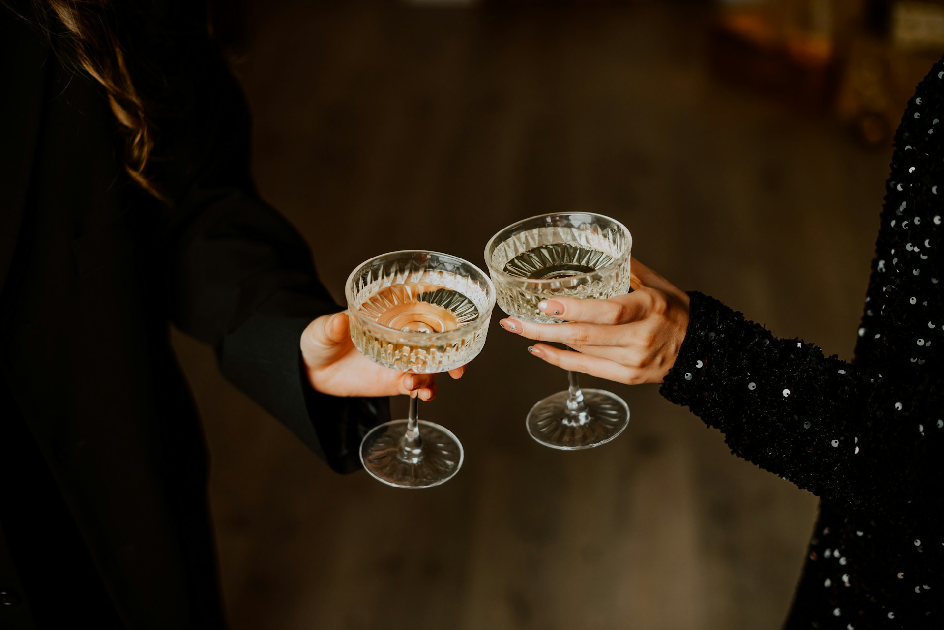 Two people clinking champagne glasses