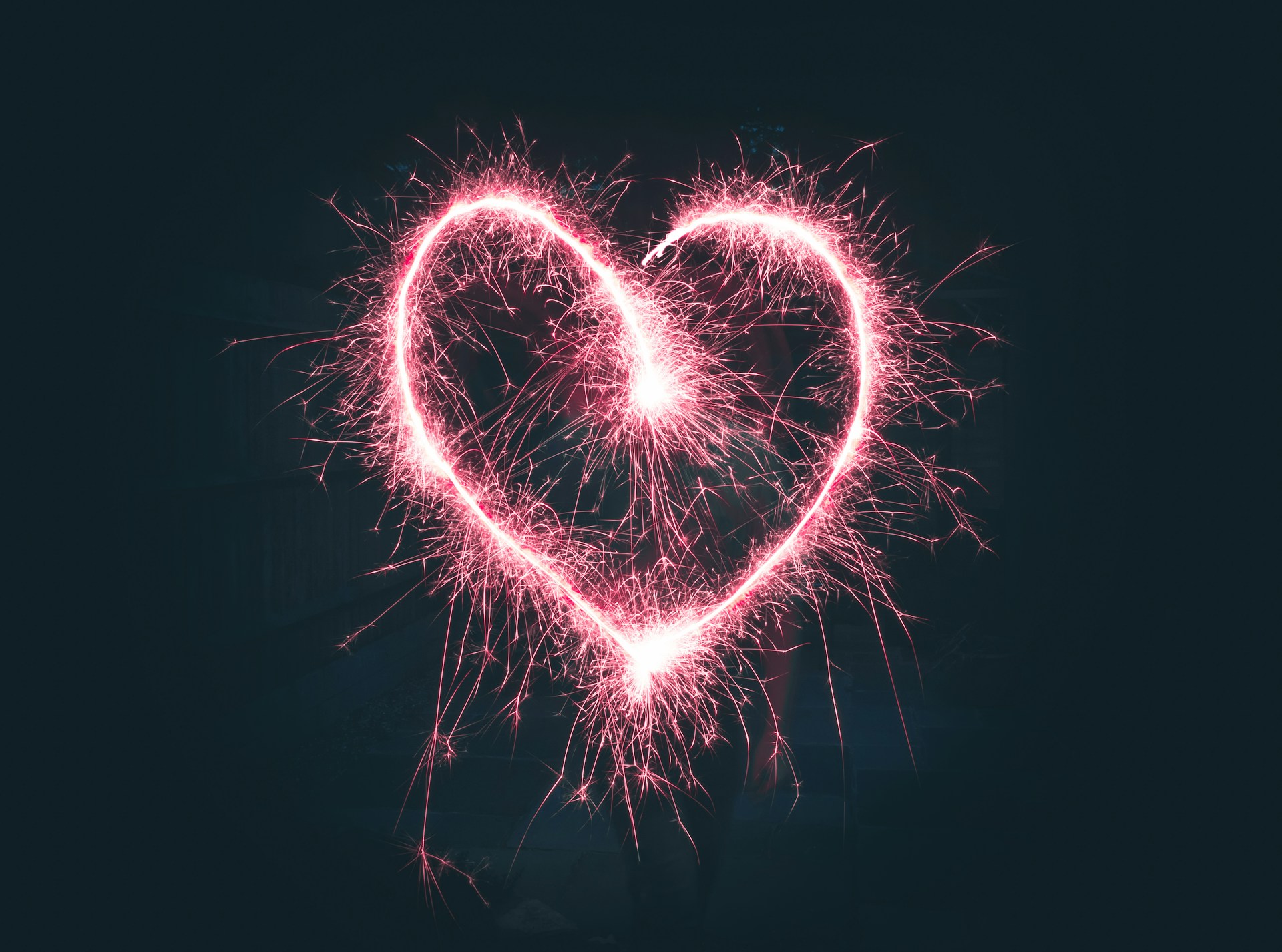 a pink heart made by a sparkler