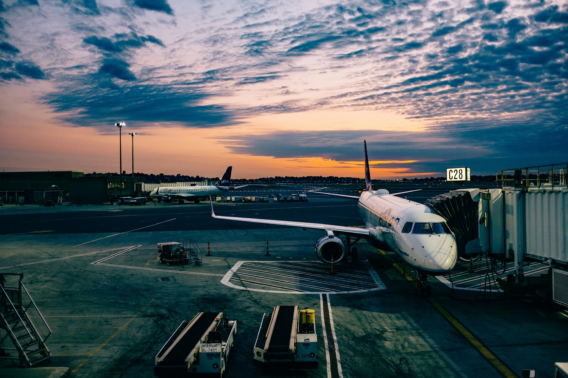 A plane in an airport at sunset