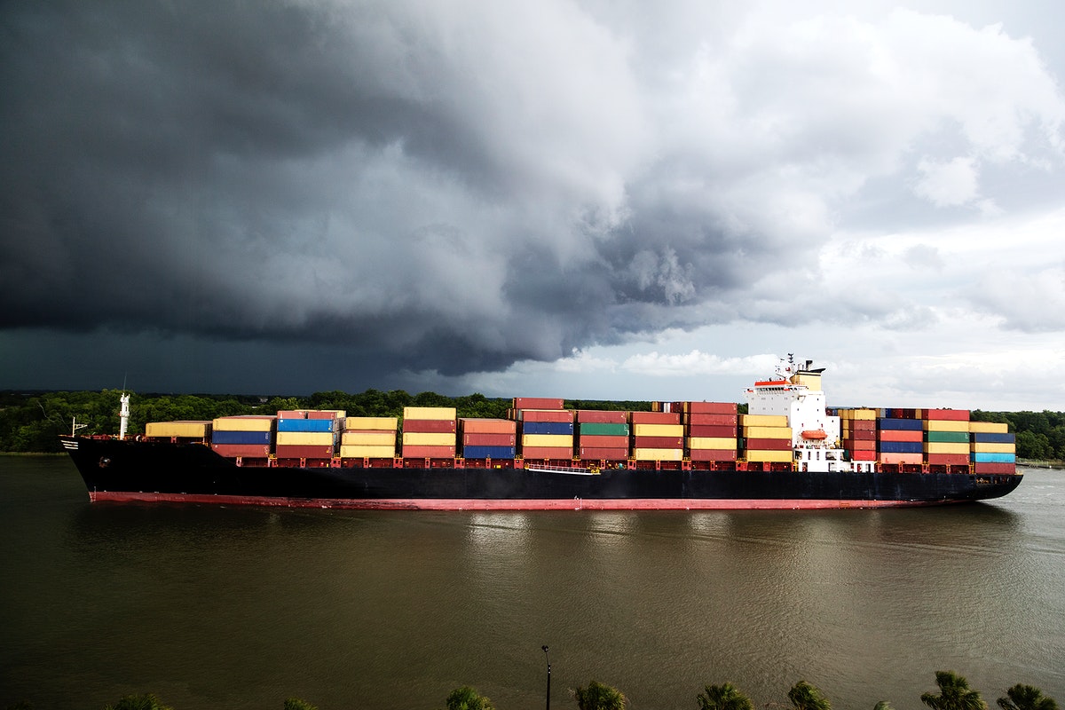 A container ship under a cloudy sky