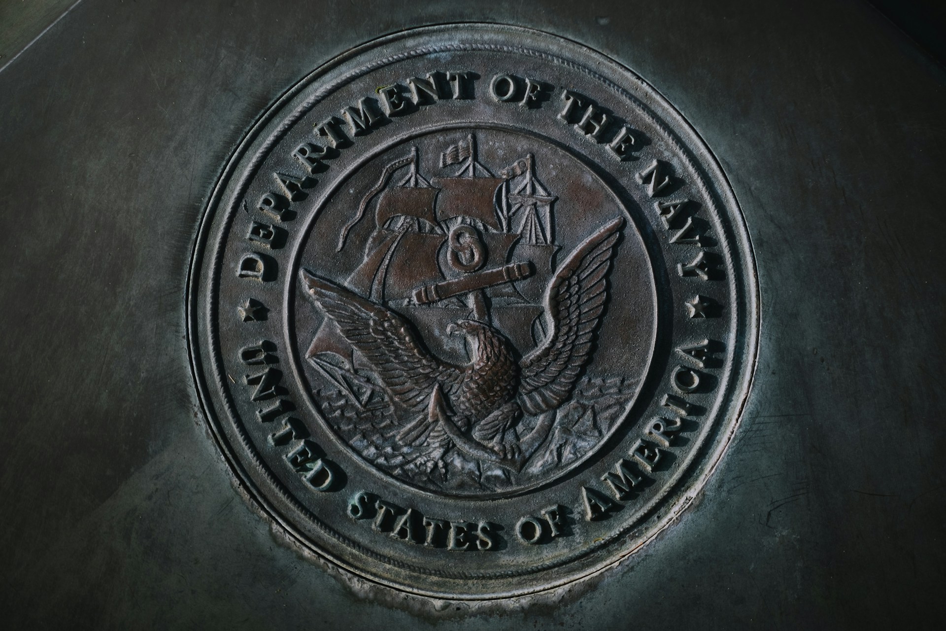 A metal stamp depicting the logo of the US Navy