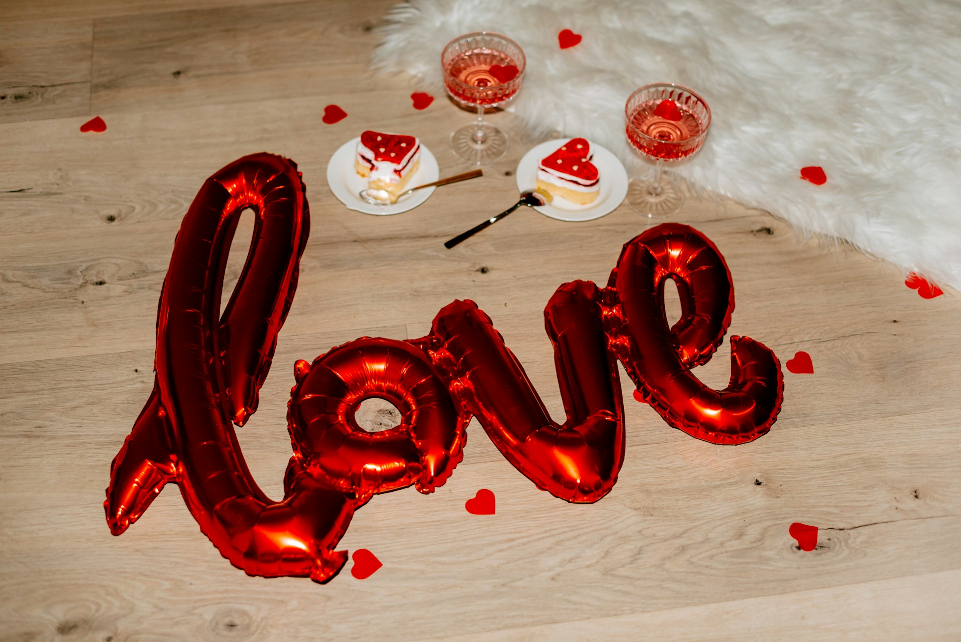 Balloons spelling 'love' and heart shaped cakes