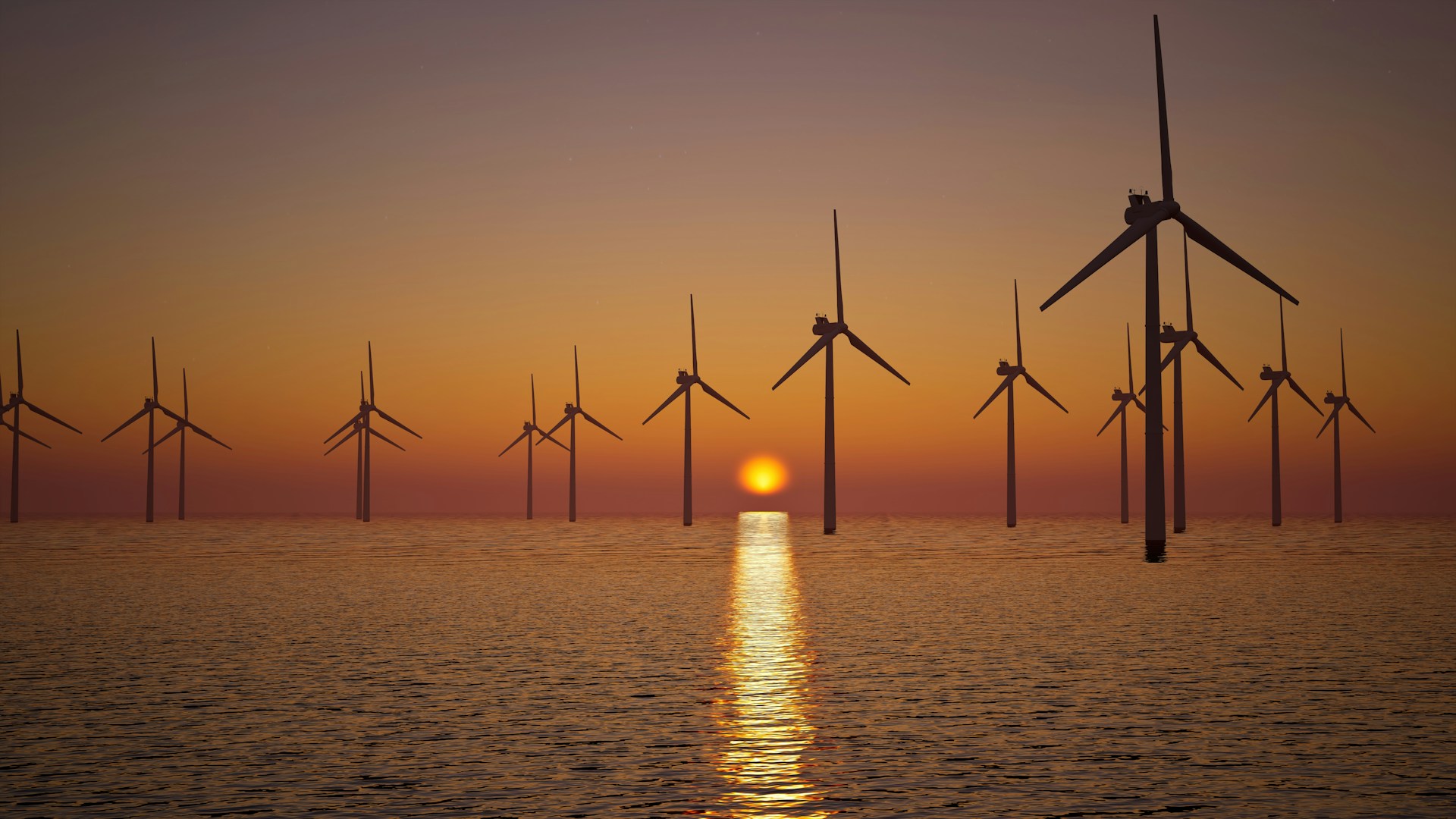 An offshore windfarm at sunset