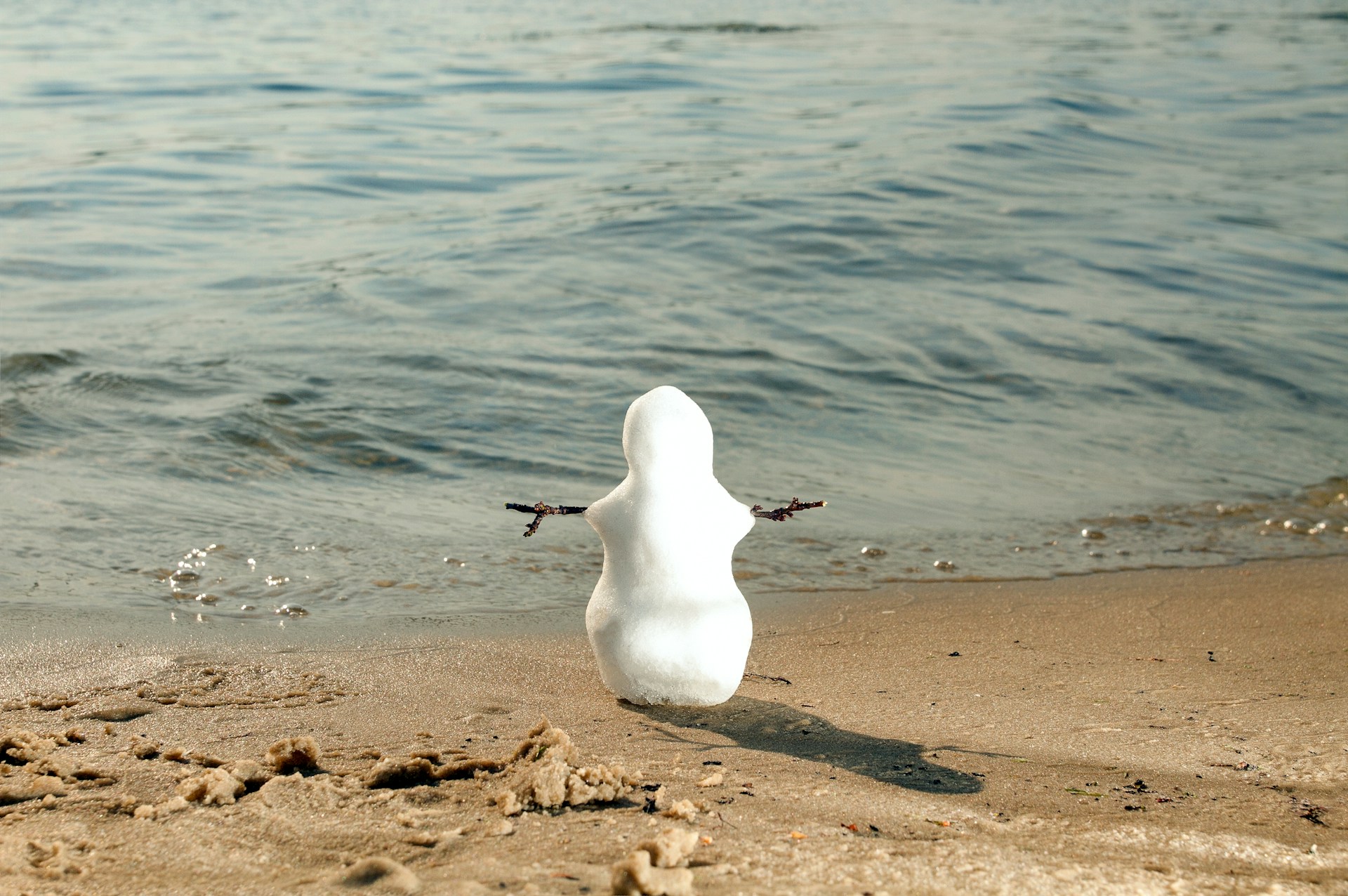 A mini snowman on a beach