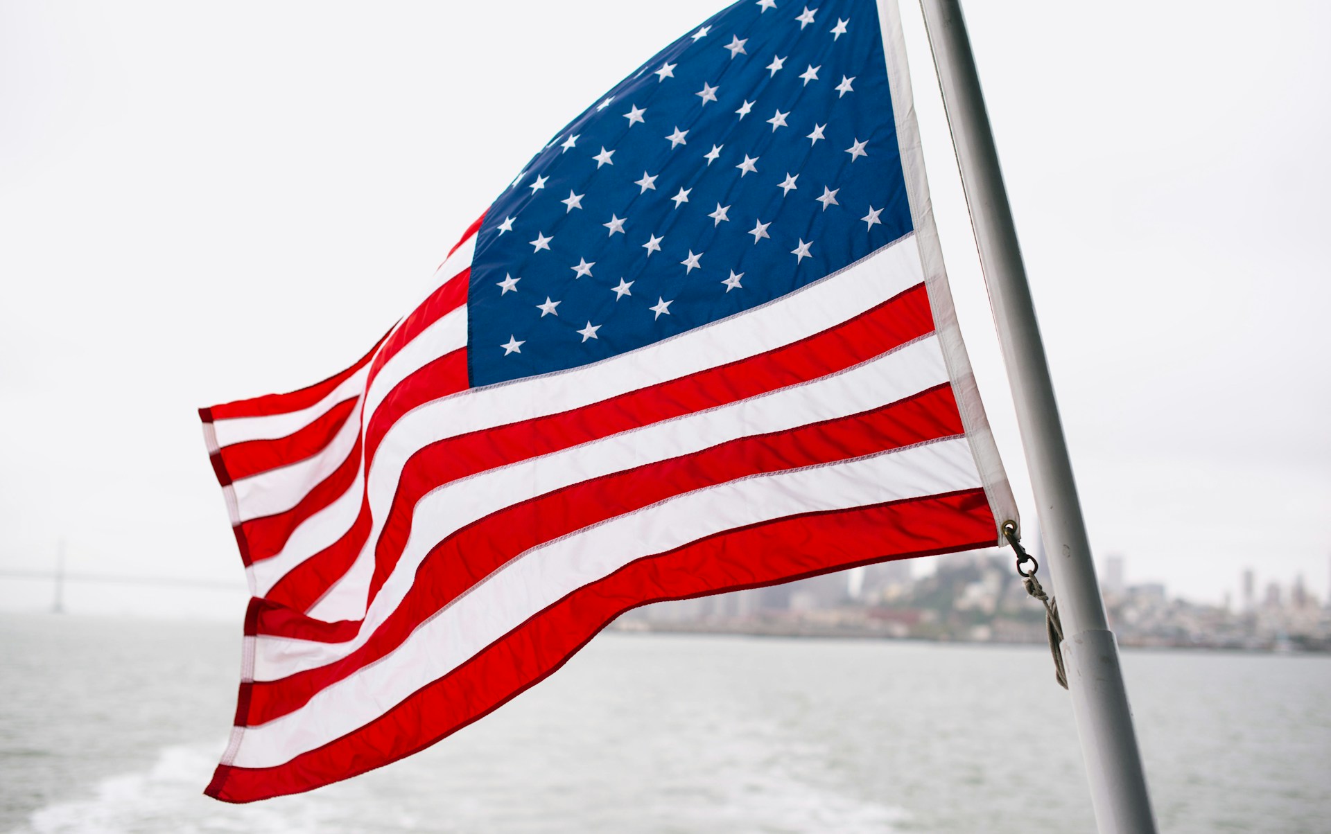 The Stars and Stripes flying off the stern of a boat