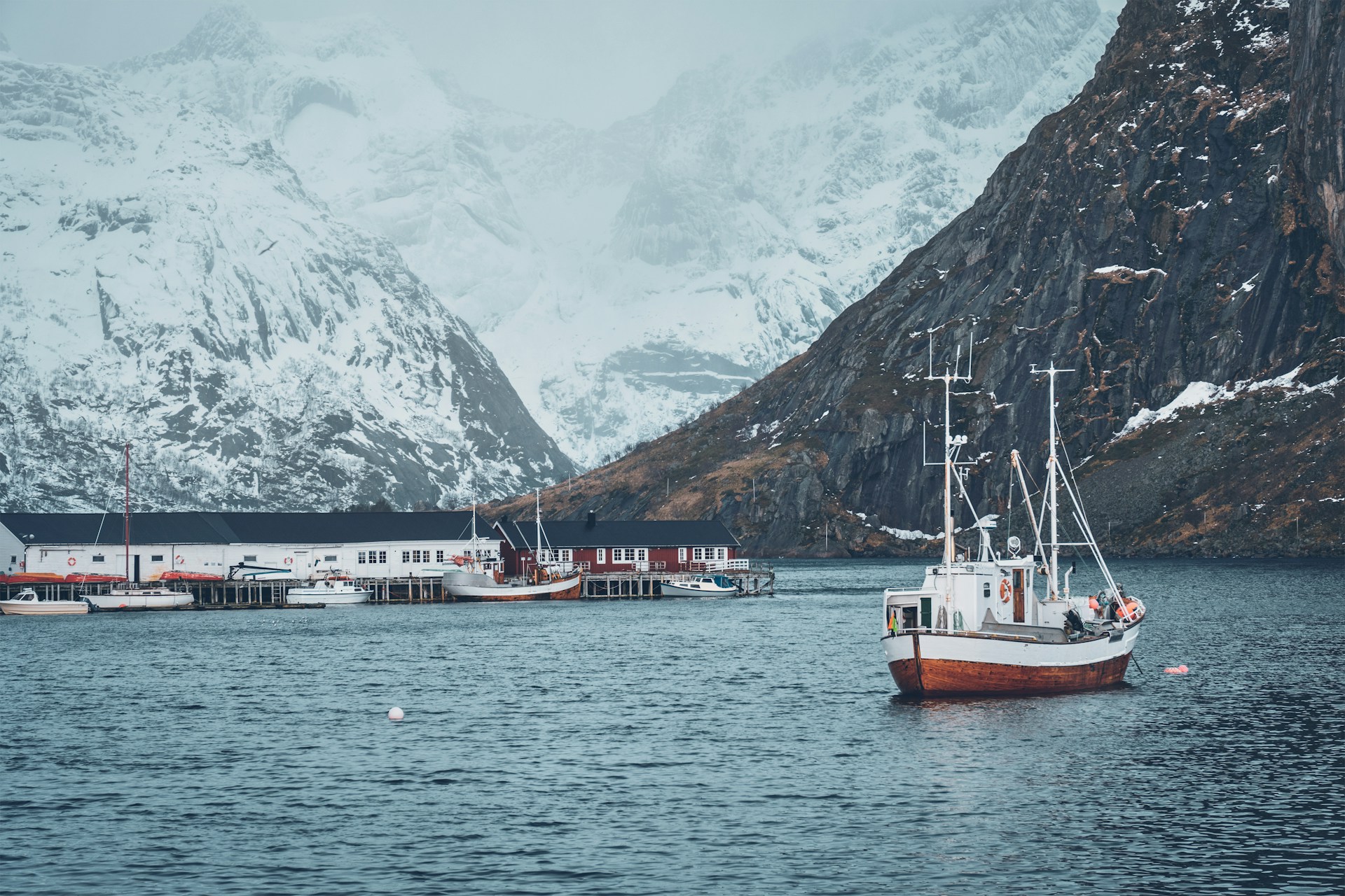 A fishing boat surrouned by mountains