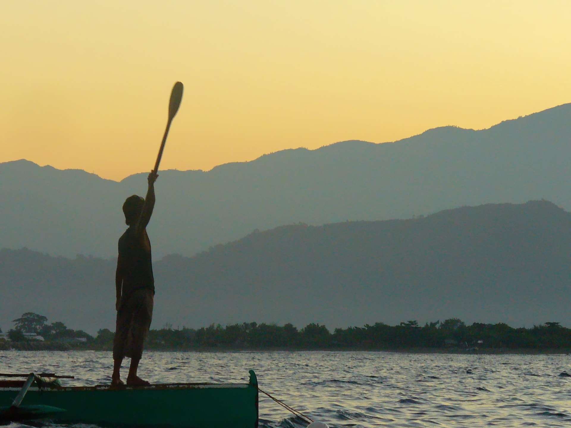 Silhouette of a statue and mountains in the Philippines' South China Sea