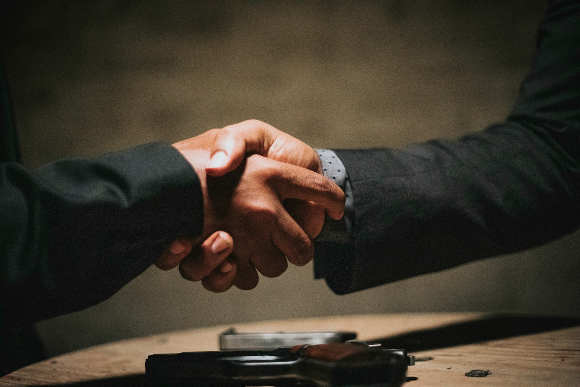 Two people in business attire shaking hands