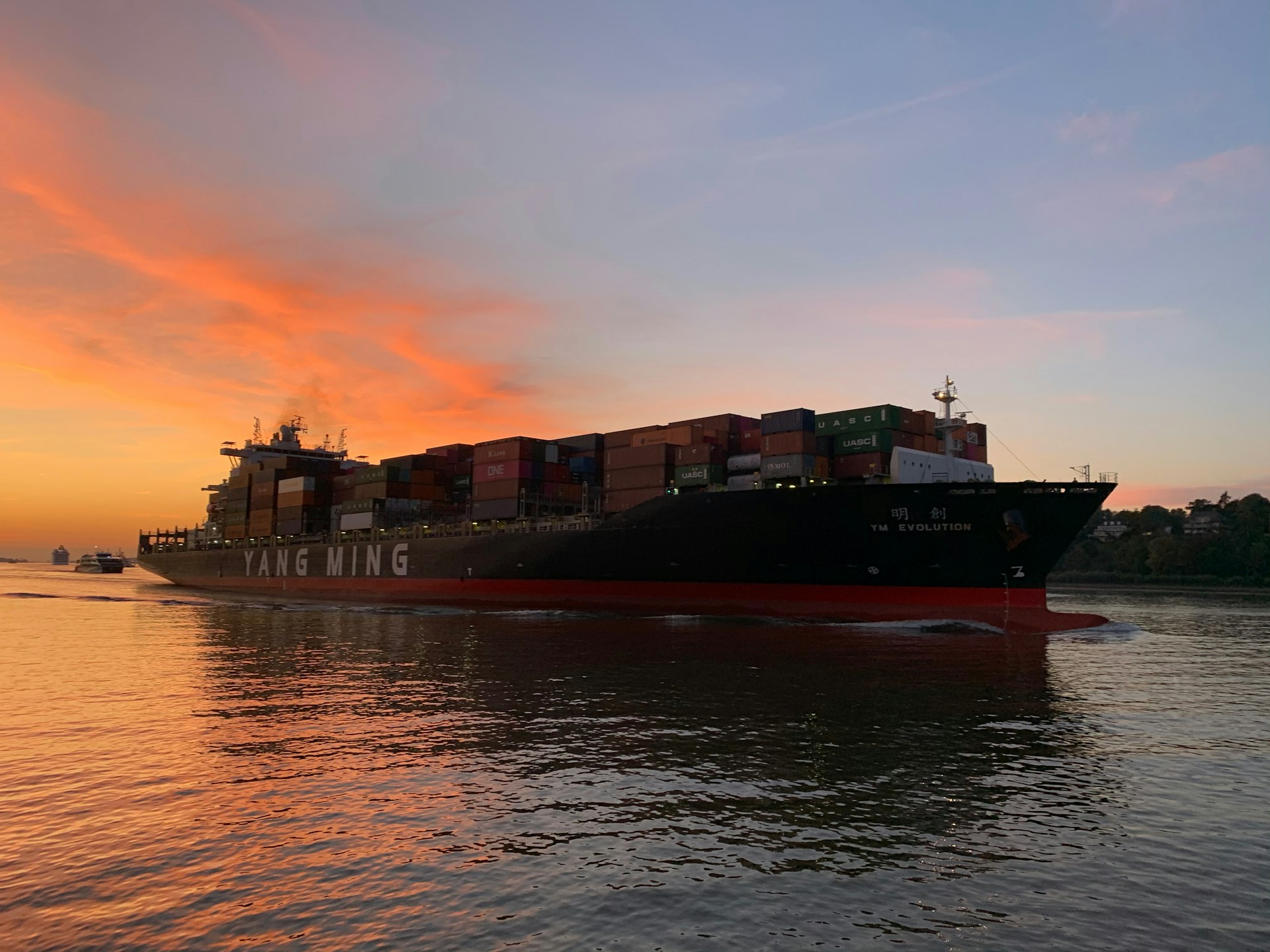 A Yang Ming container ship at sunset