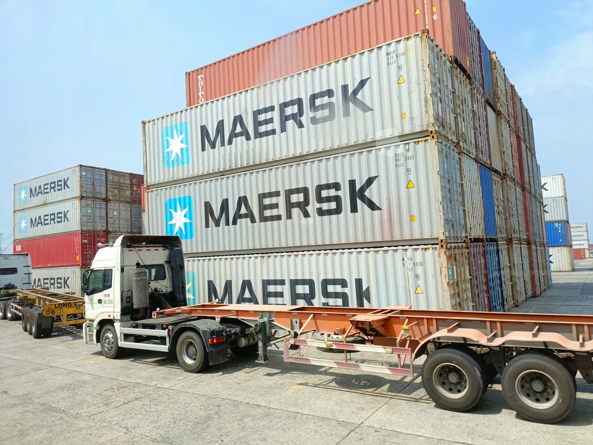 Maersk shipping containers and truck in port