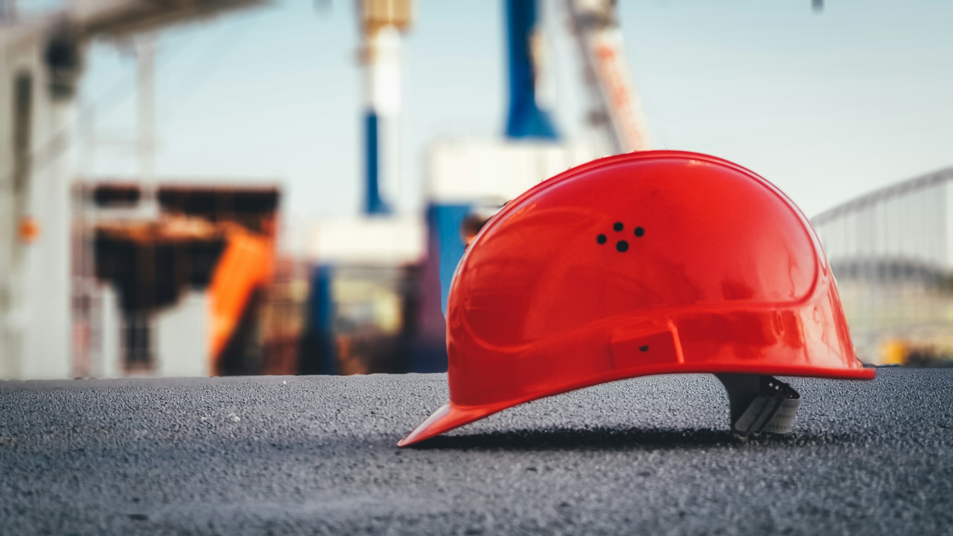 A hard hat on the ground in a shipyard