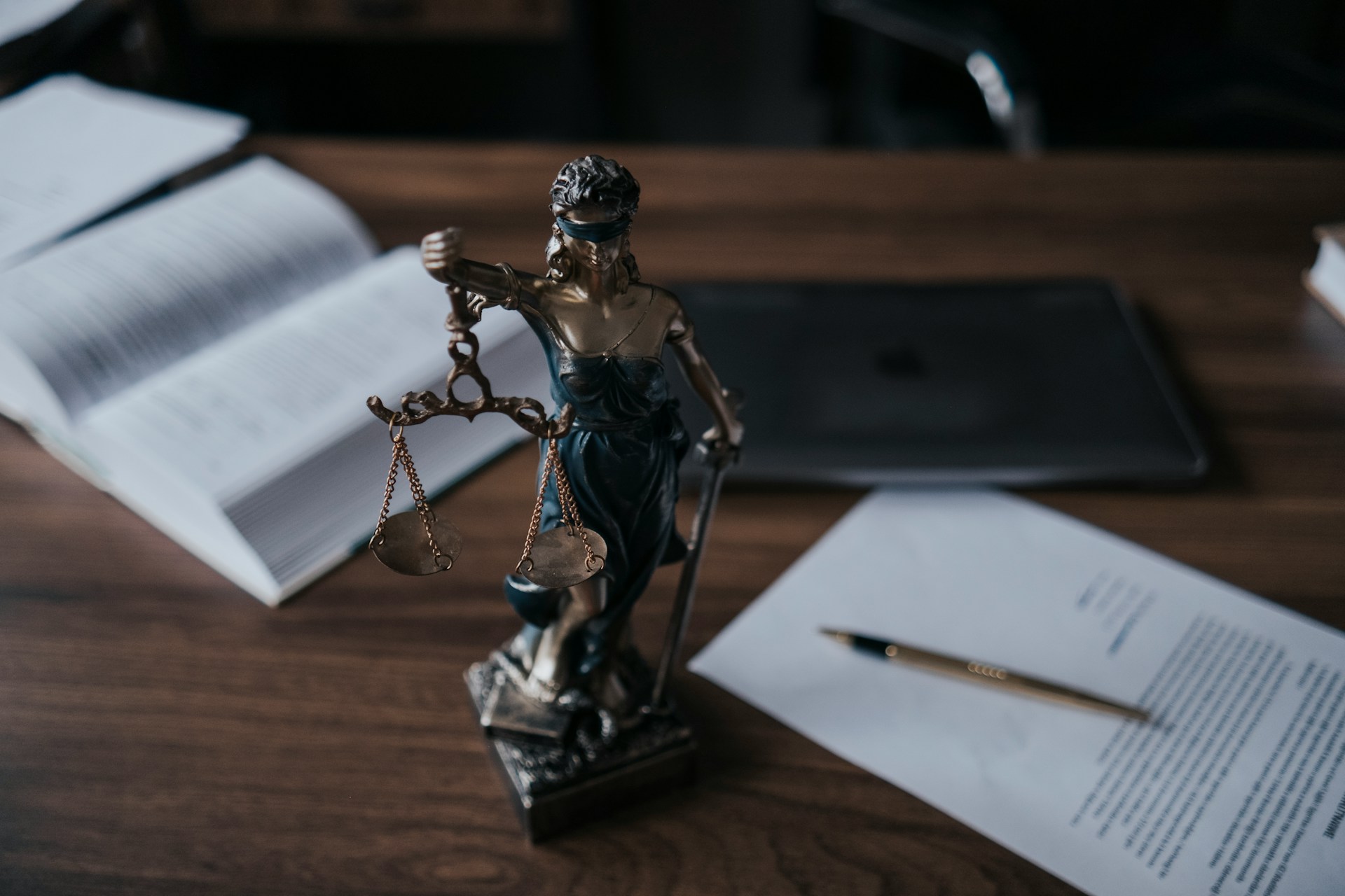 Legal documents and a small statuette of Lady Justice