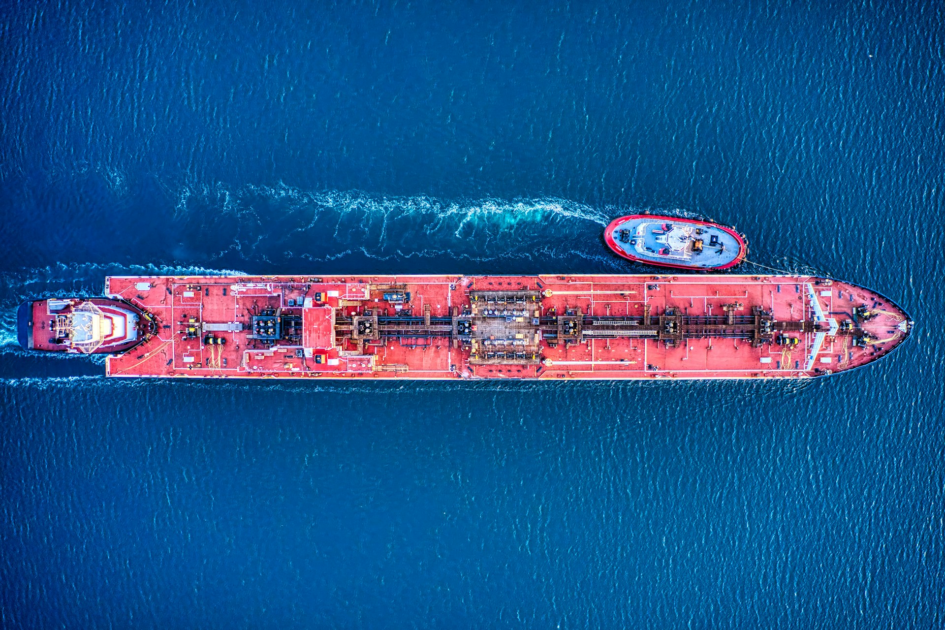 Aerial view of a large oil tanker and tugbpat