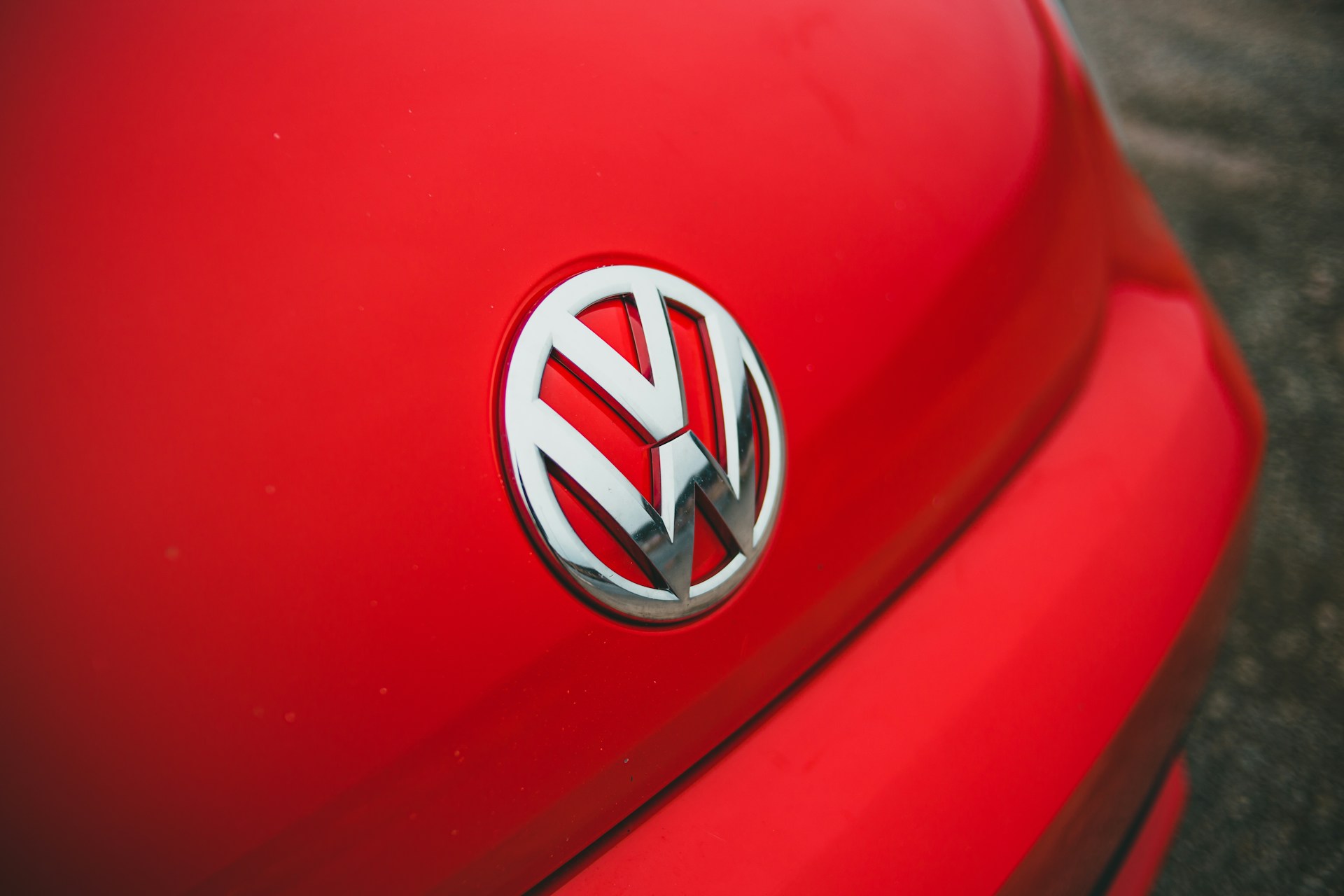 A Volkswagen badge on a red car