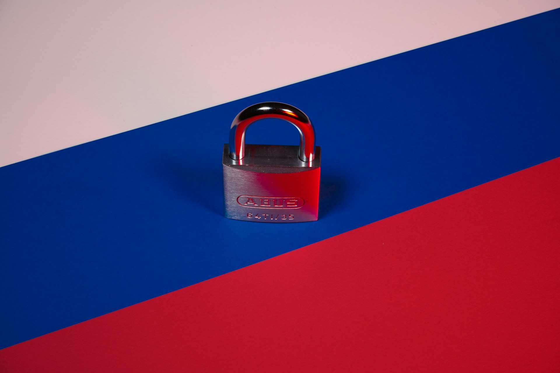 Close up of the Russian flag with a padlock on it