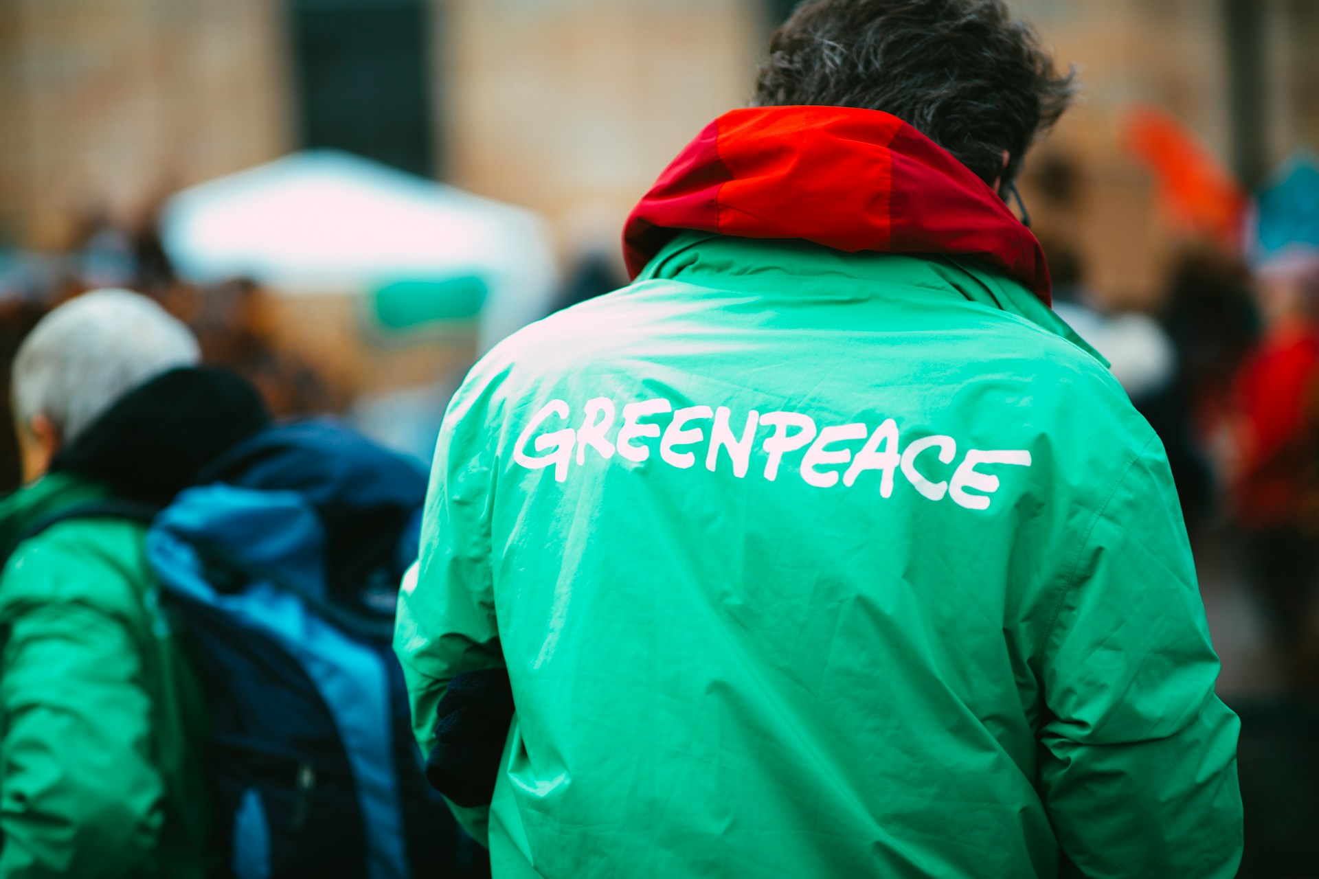 a man wearing a Greenpeace jacket